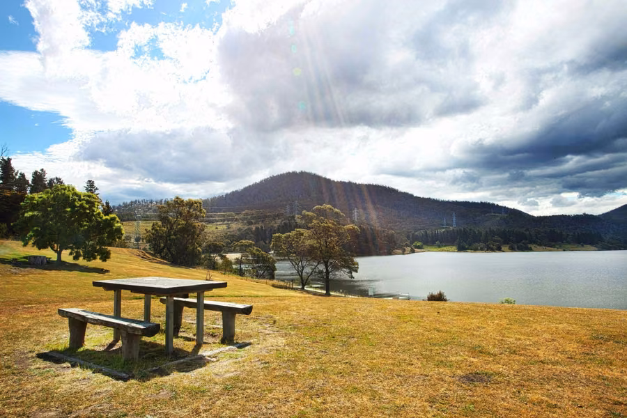 Riverside picnic lawn at Discovery Parks Hobart on the Derwent's eastern shore