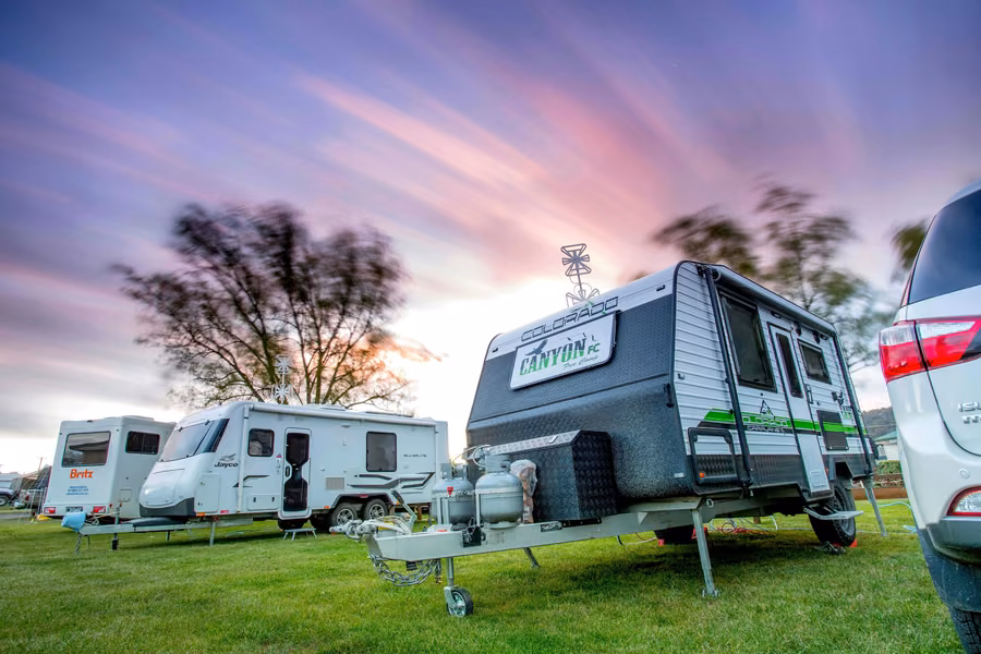 Caravans on powered sites at sunset at Discovery Parks Hadspen