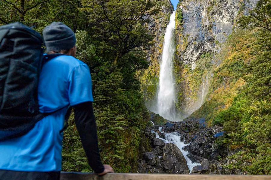 Walker below Devils Punchbowl Falls in Arthur's Pass National Park