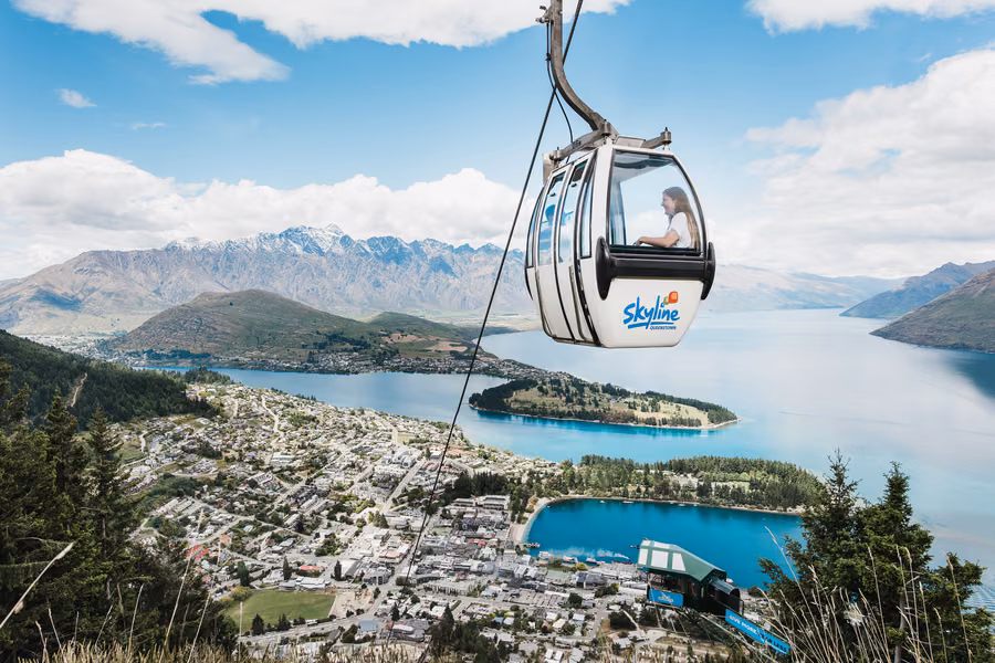 Skyline Gondola cabin above Queenstown and Lake Wakatipu with The Remarkables behind