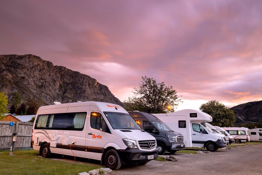 Britz campervan and motorhomes on powered sites at dusk at Queenstown TOP 10 Holiday Park