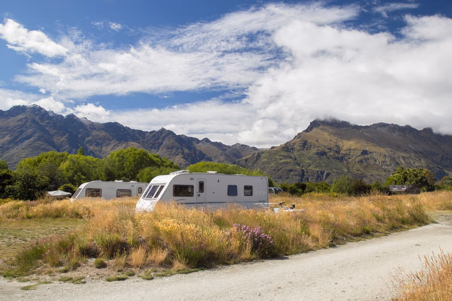 Motorhome and caravan at Twelve Mile Delta DOC campsite near Lake Wakatipu