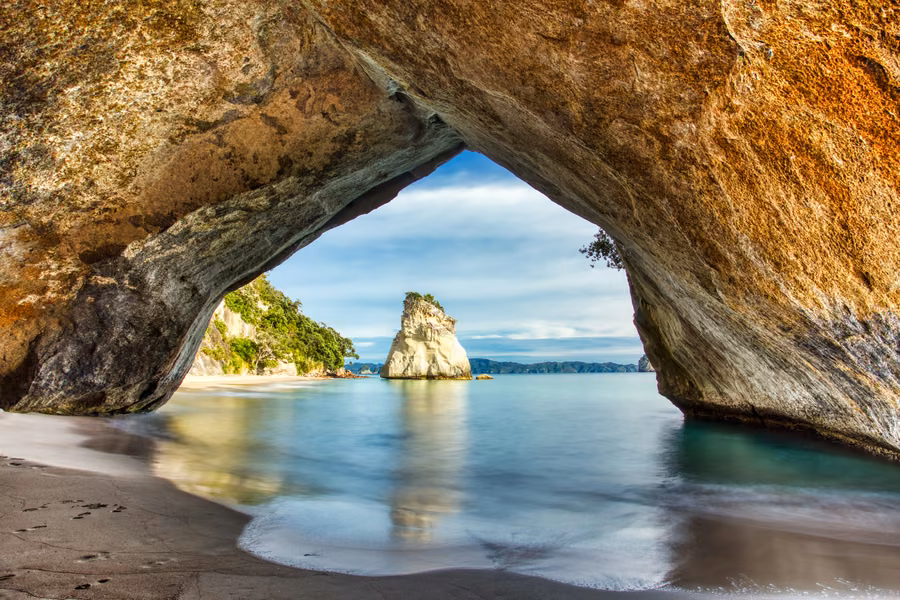 View through the rock archway at Mautohe Cathedral Cove to Te Hoho rock