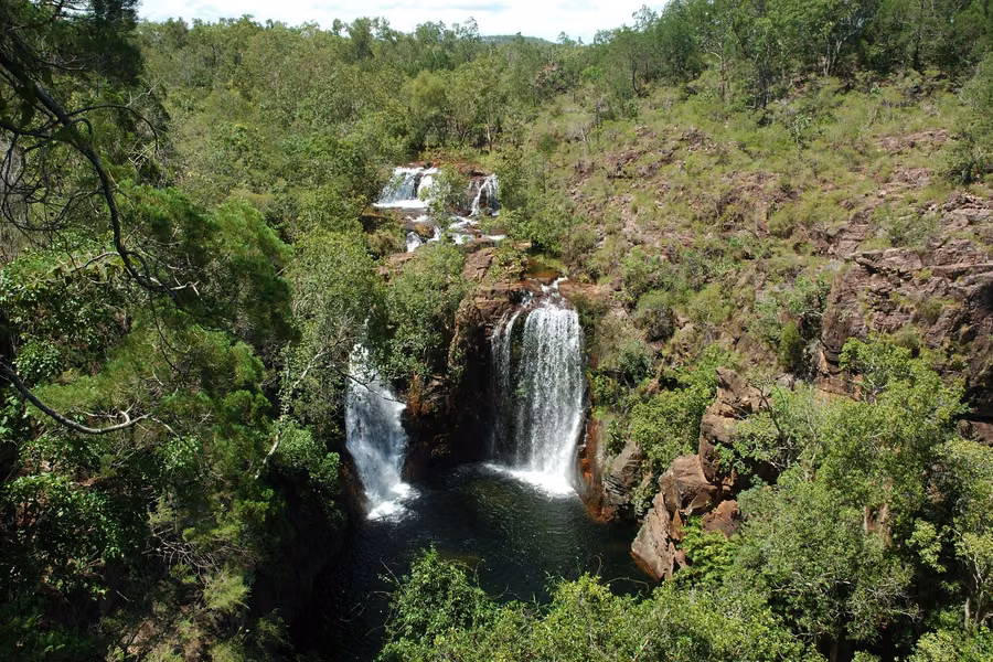 Florence Falls pouring in two streams into a plunge pool surrounded by monsoon forest in Litchfield National Park