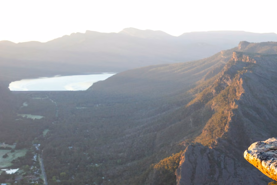 Golden light over a rocky ridge, the Halls Gap valley and Lake Bellfield, seen from Boroka Lookout in the Grampians