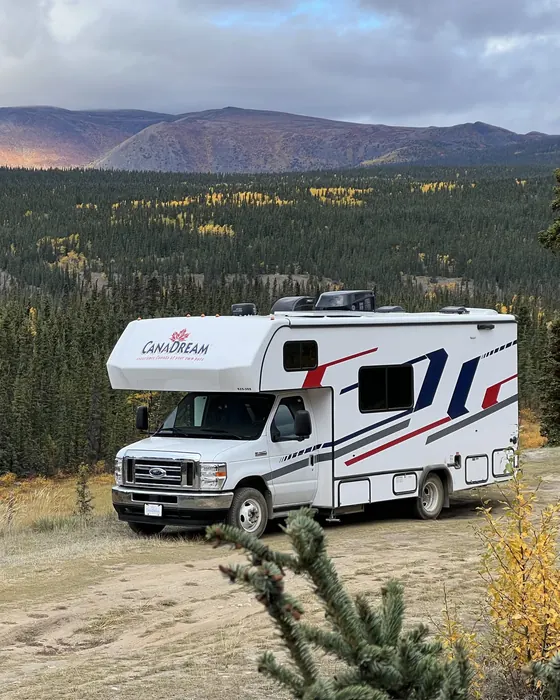 Motorhome parked at a forest lookout below the mountains in Canada
