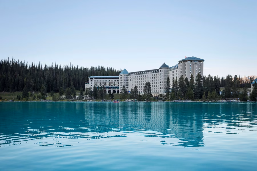 Turquoise Lake Louise with the Fairmont Chateau Lake Louise and pine forest on the far shore under a clear sky