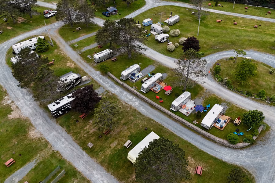 Aerial view of Shubie Campground's gravel loops, with RVs and vintage Airstream trailers on grassy sites