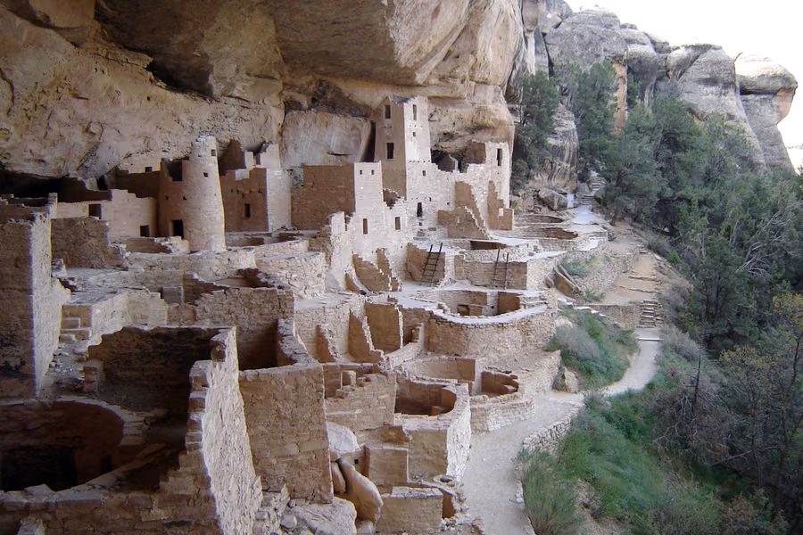 Stone towers, rooms and round kivas of Cliff Palace under a sandstone overhang at Mesa Verde National Park
