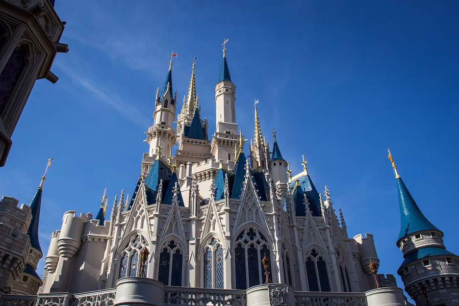 Blue-roofed spires of Cinderella Castle at Magic Kingdom, Walt Disney World, against a clear blue sky