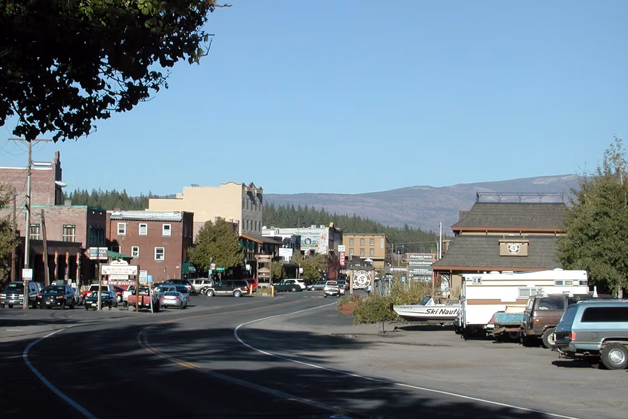 Downtown Truckee main street with brick buildings and forested Sierra hills behind