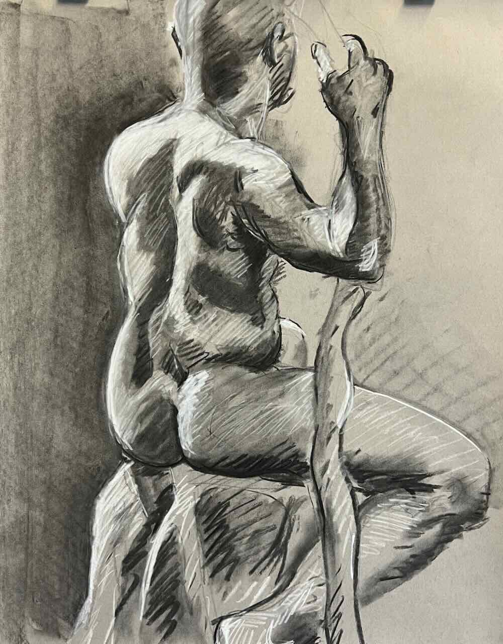 Seated male model, rendered in charcoal