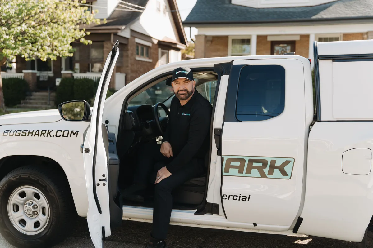 Bug Shark technician at work outside a home