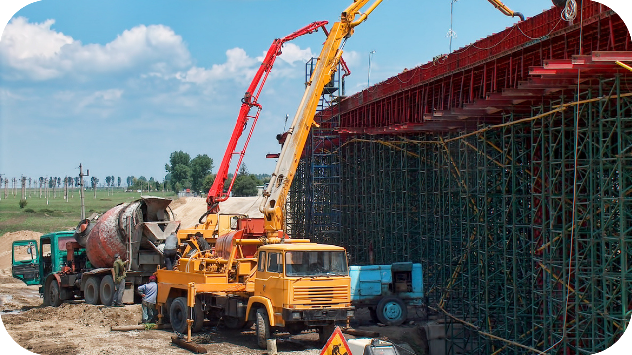 a boom pump delivering concrete at a high-rise building on a construction site