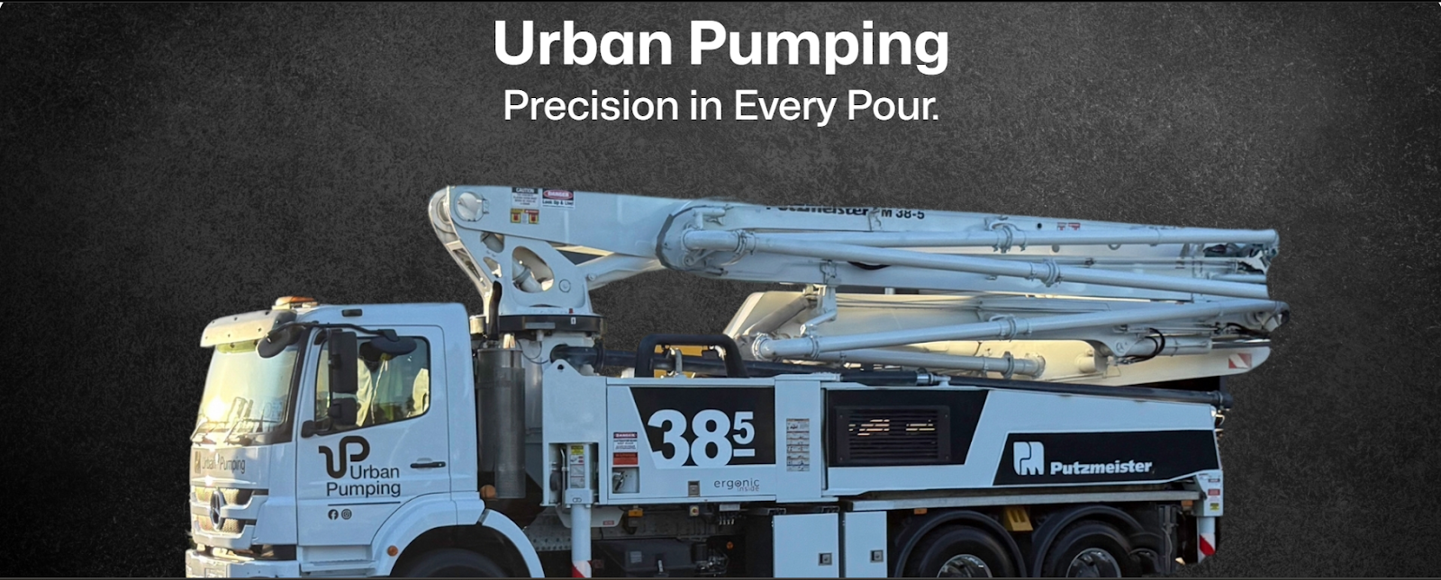 White Urban Pumping boom pump truck with Putzmeister branding parked against a dark backdrop, showcasing the 38.5-metre pump arm.