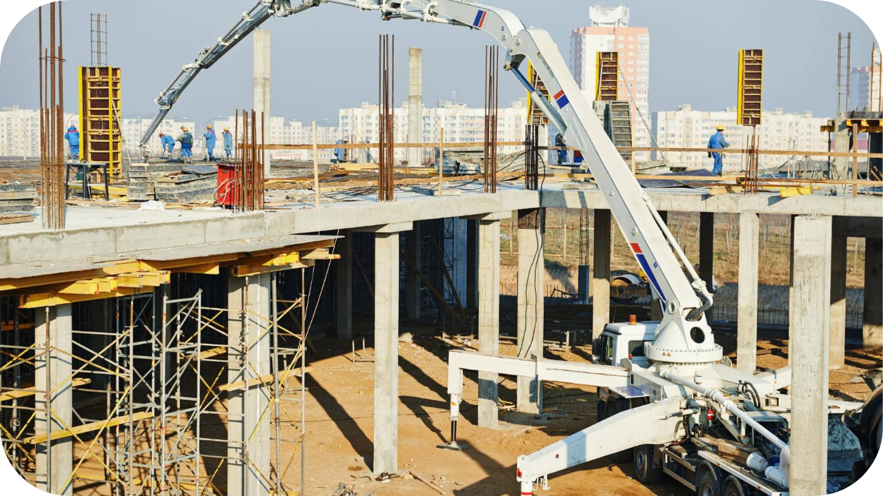 Large boom pump extending on a multi-storey construction site, delivering precise concrete placement for structural framework.