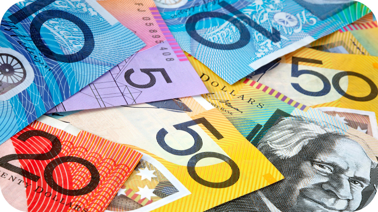 Australian banknotes in denominations of five, ten, twenty, and fifty spread out, symbolising construction costs and project budgeting.