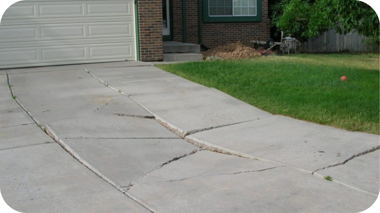 Workers using concrete pumping equipment on a slab showing uneven settlement to ensure proper levelling and stability.