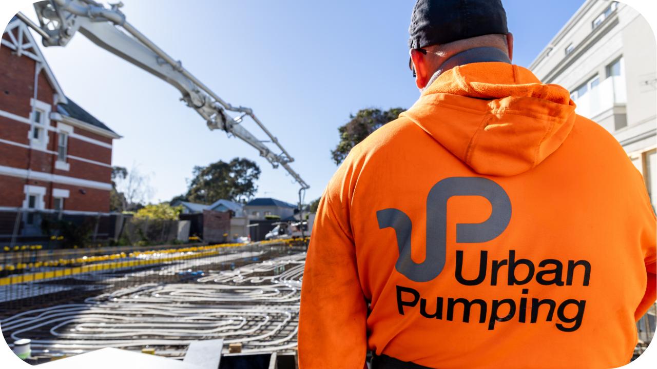 Urban Pumping worker overseeing concrete pumping operations on a residential construction site in Melbourne.