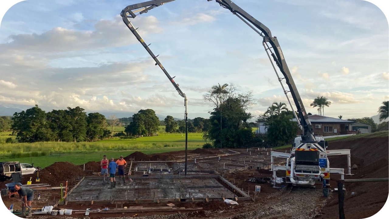 Boom pump positioned over a large foundation as workers guide the pour, emphasising safe concrete pumping practices on Melbourne construction sites