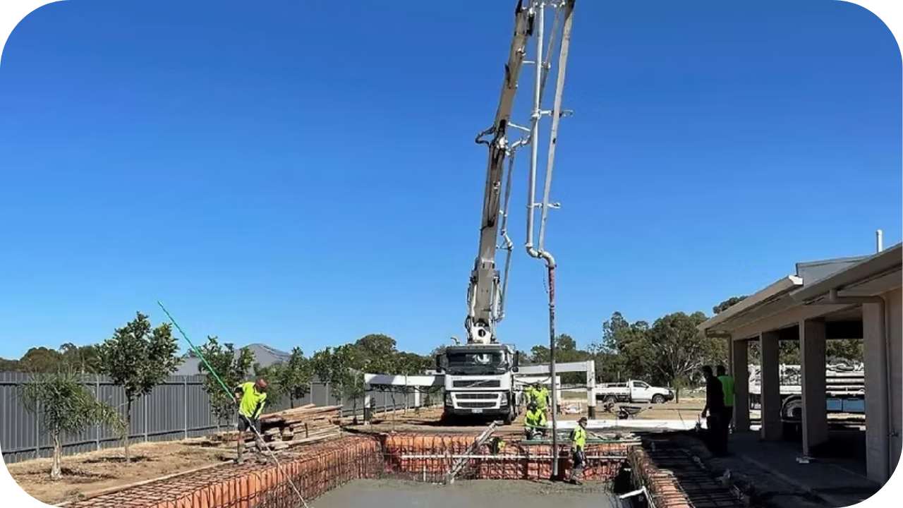 Concrete crew guiding a boom pump as it pours a foundation slab, demonstrating safe and controlled pumping practices on Melbourne construction sites