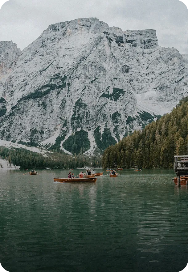 A couple of boats floating on top of a lake.