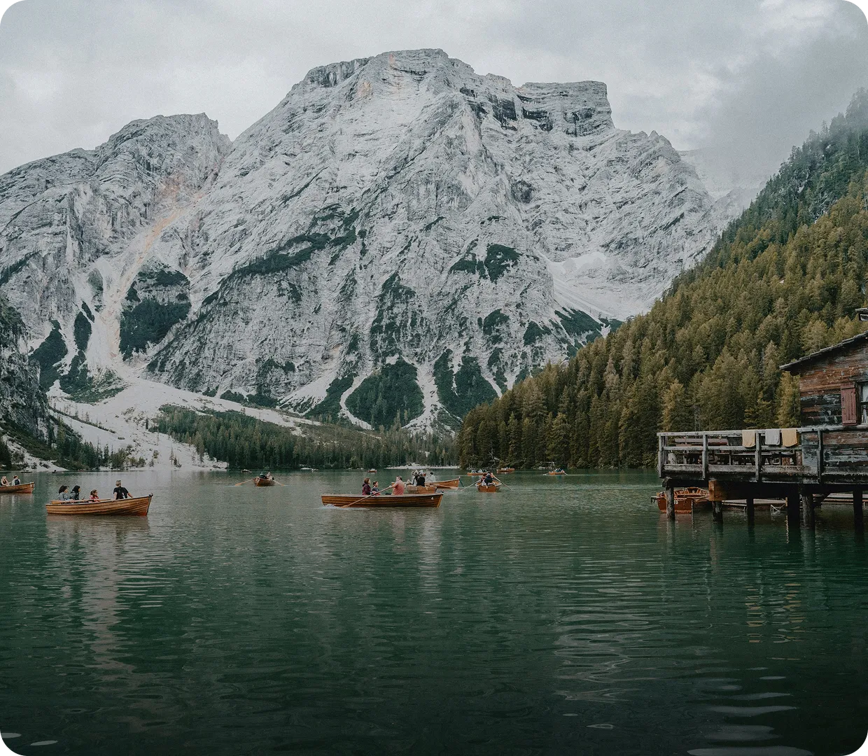 A group of people in small boats on a lake.