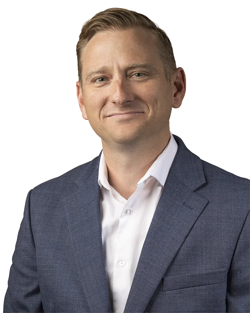 Audiologist wearing a blue suit jacket and white dress shirt.