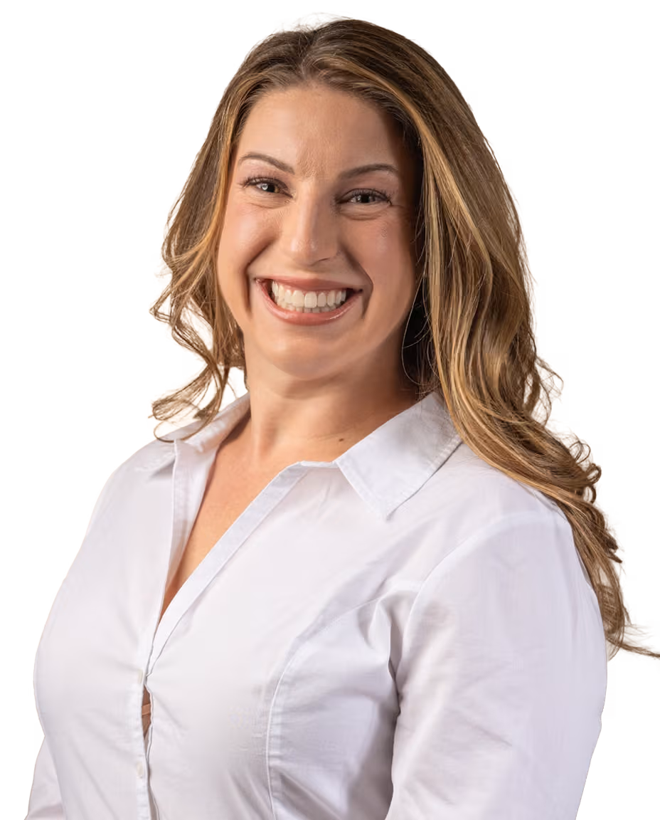 Smiling female audiologist with long light brown hair wearing a white button-up shirt.