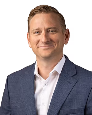 Audiologist wearing a white dress shirt and blue blazer.