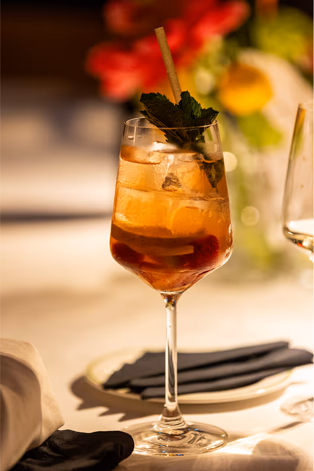 A glass of wine and a glass of wine on a table.
