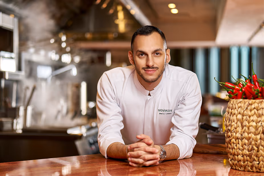 Chef Marco Lubian at a table in a Novikov Abu Dhabi kitchen.