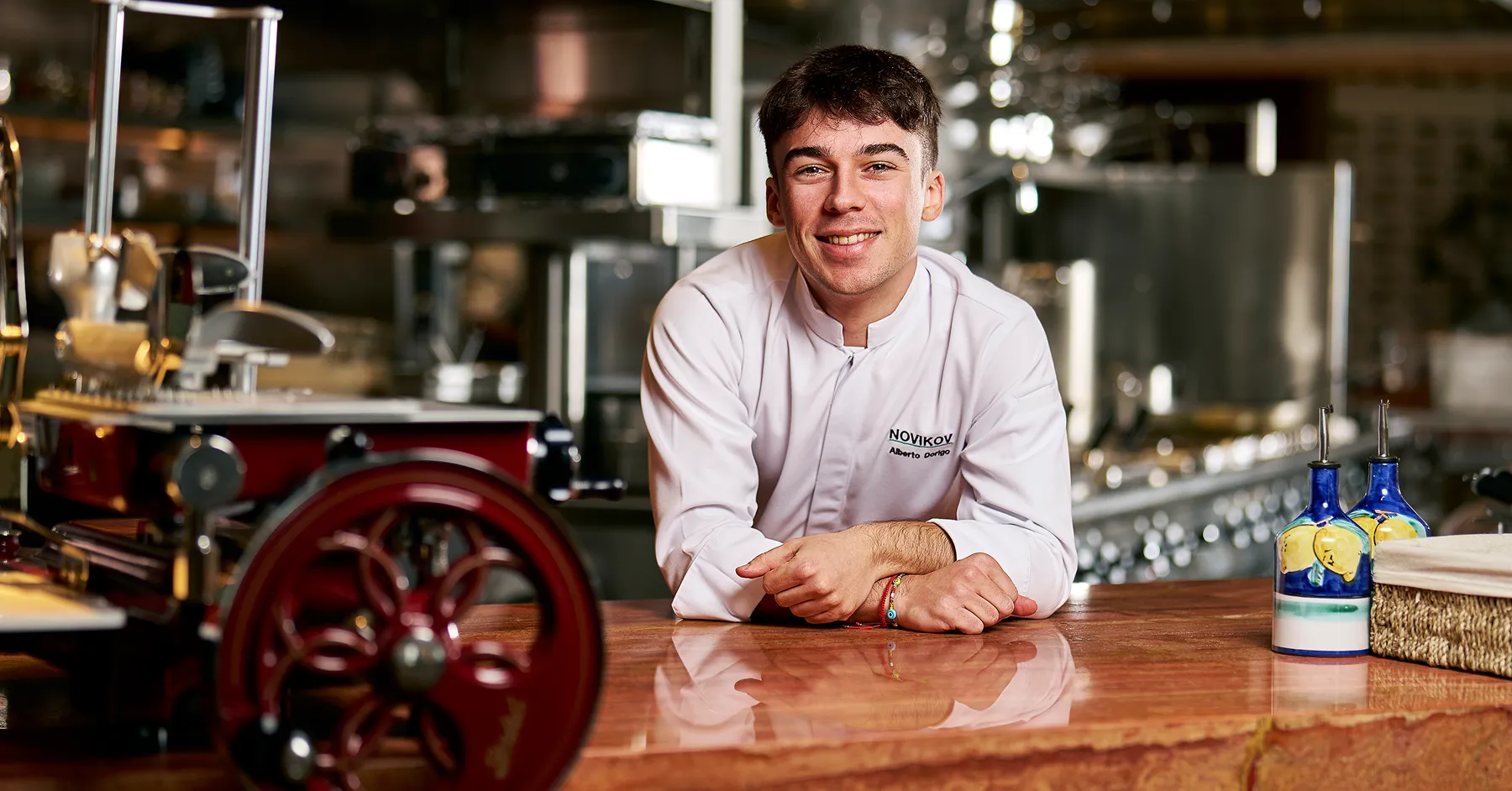 A man sitting at a counter in a kitchen.