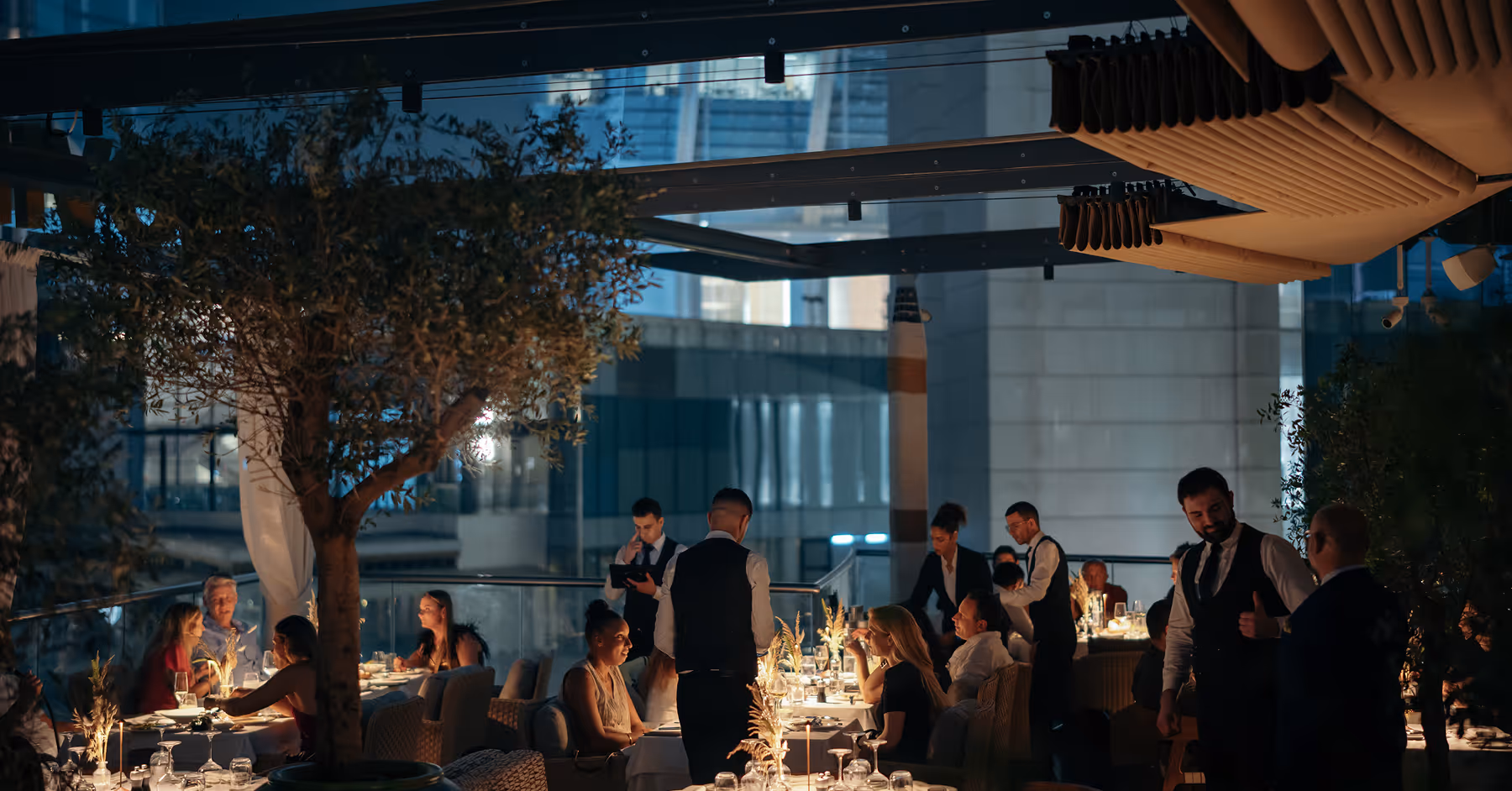 A group of people sitting at tables in a restaurant.