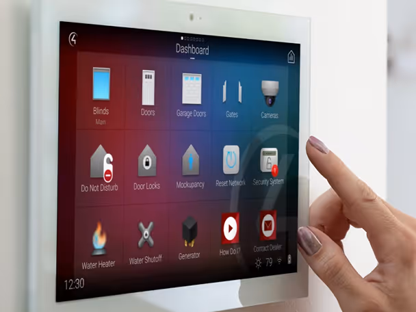 Hand interacting with a smart home control panel showing icons for blinds, doors, security system, water heater, and other home automation features.