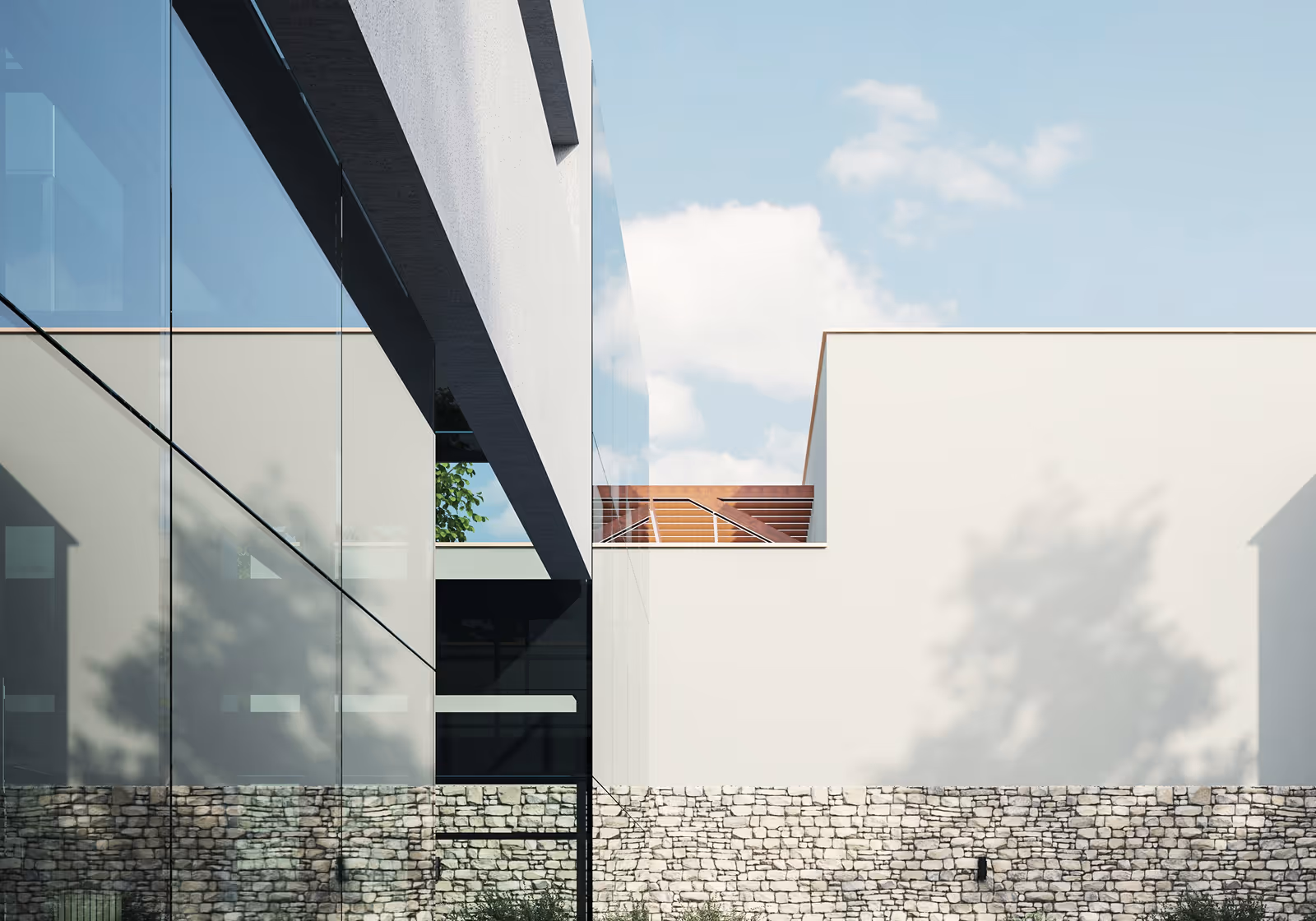 Modern building exterior with large reflective glass windows, white walls, and stone base under a partly cloudy sky.