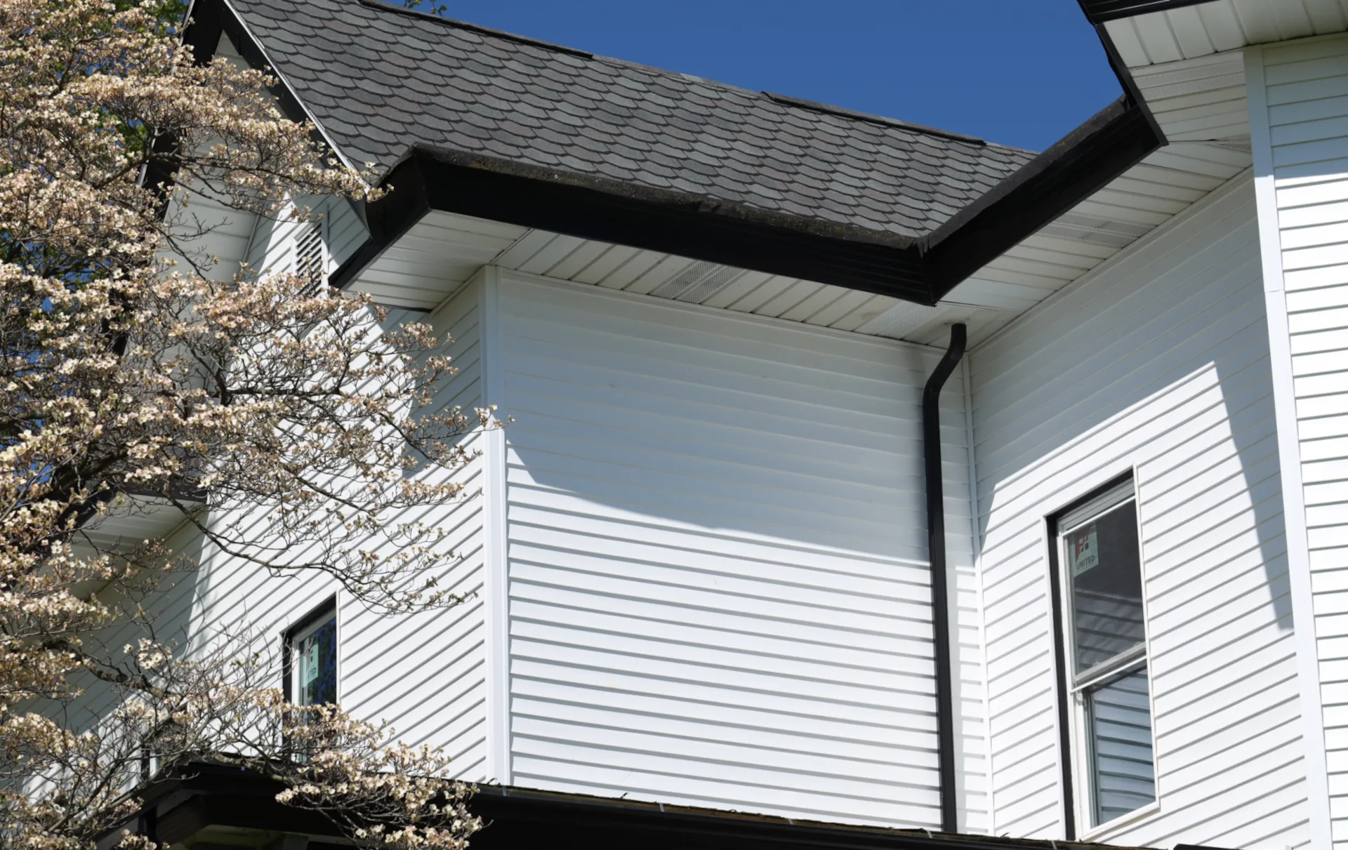 2 story house with white vinyl siding