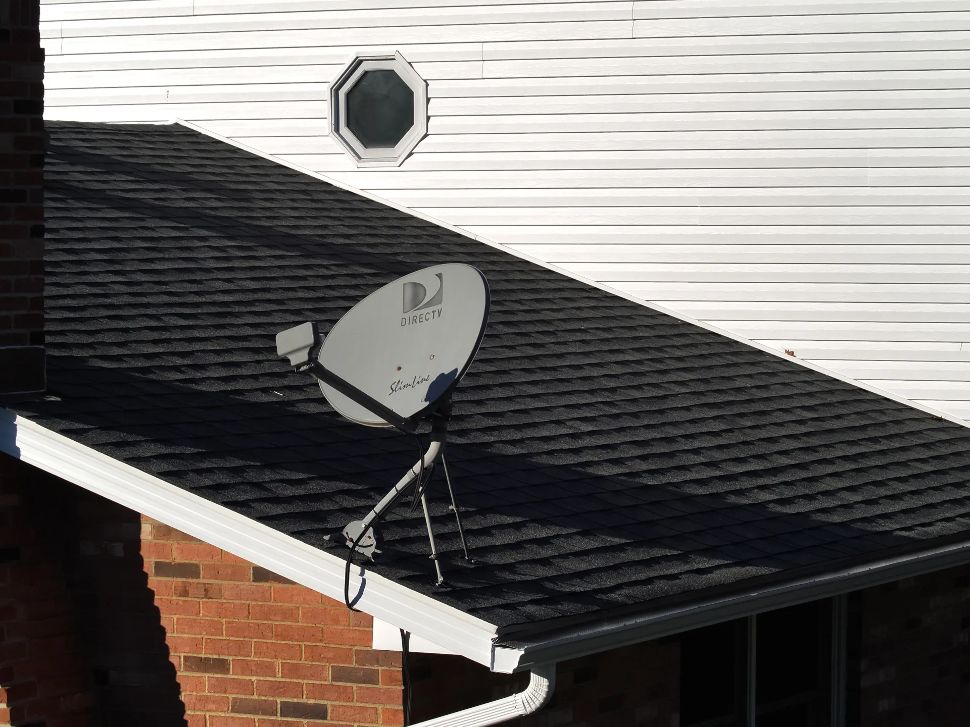 white seamless gutters on a shingle roof