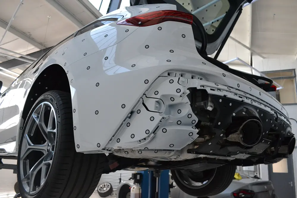 Rear of a car fitted with reference markers during a reverse engineering scan