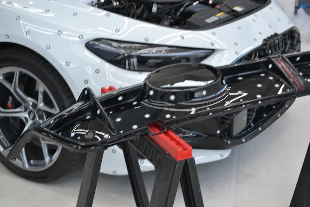 Vehicle subframe component marked up for 3D scanning ahead of reverse engineering