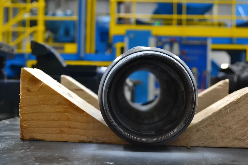 Cylindrical engineering component set on a cradle for measurement and digitisation