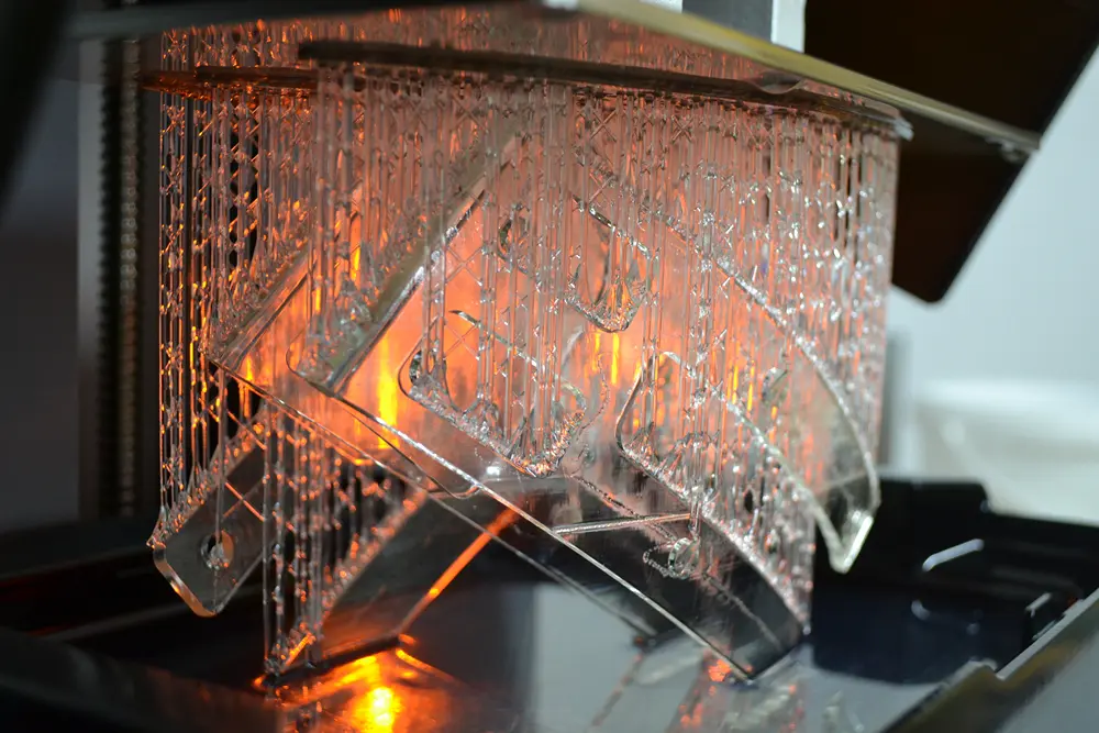 Clear SLA resin print with support structures fresh off the printer