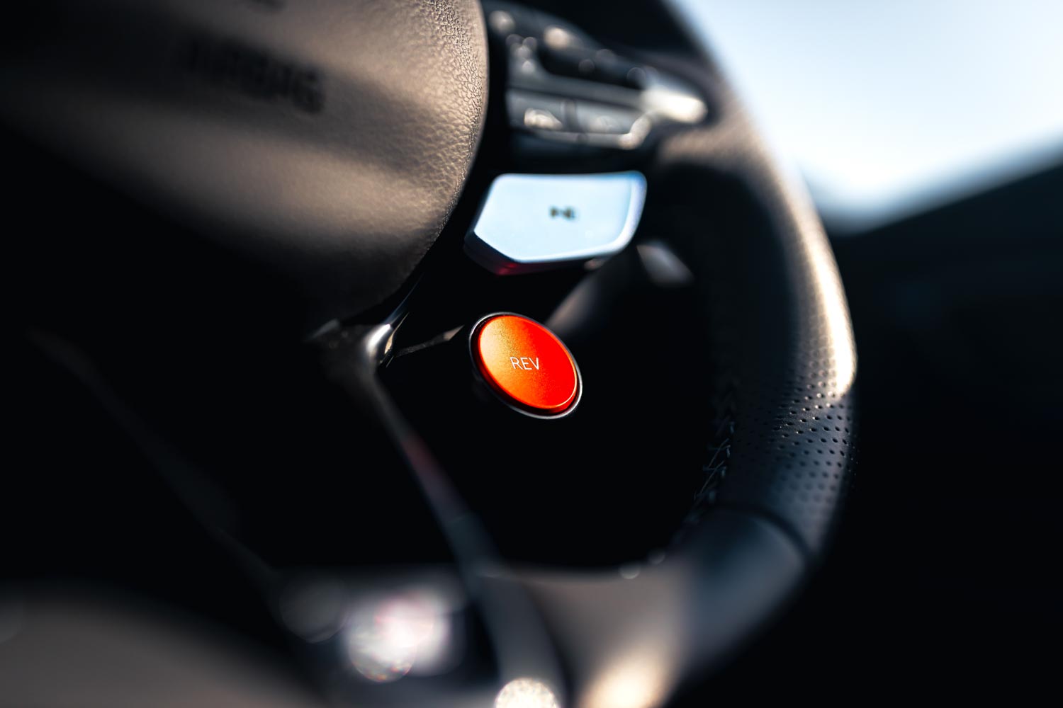 Hyundai i20N Performance Blue Rush Magazine review - close up of steering wheel with H1 and H2 dynamic buttons and large red rev matching activation button