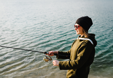 A woman holds a fishing rod