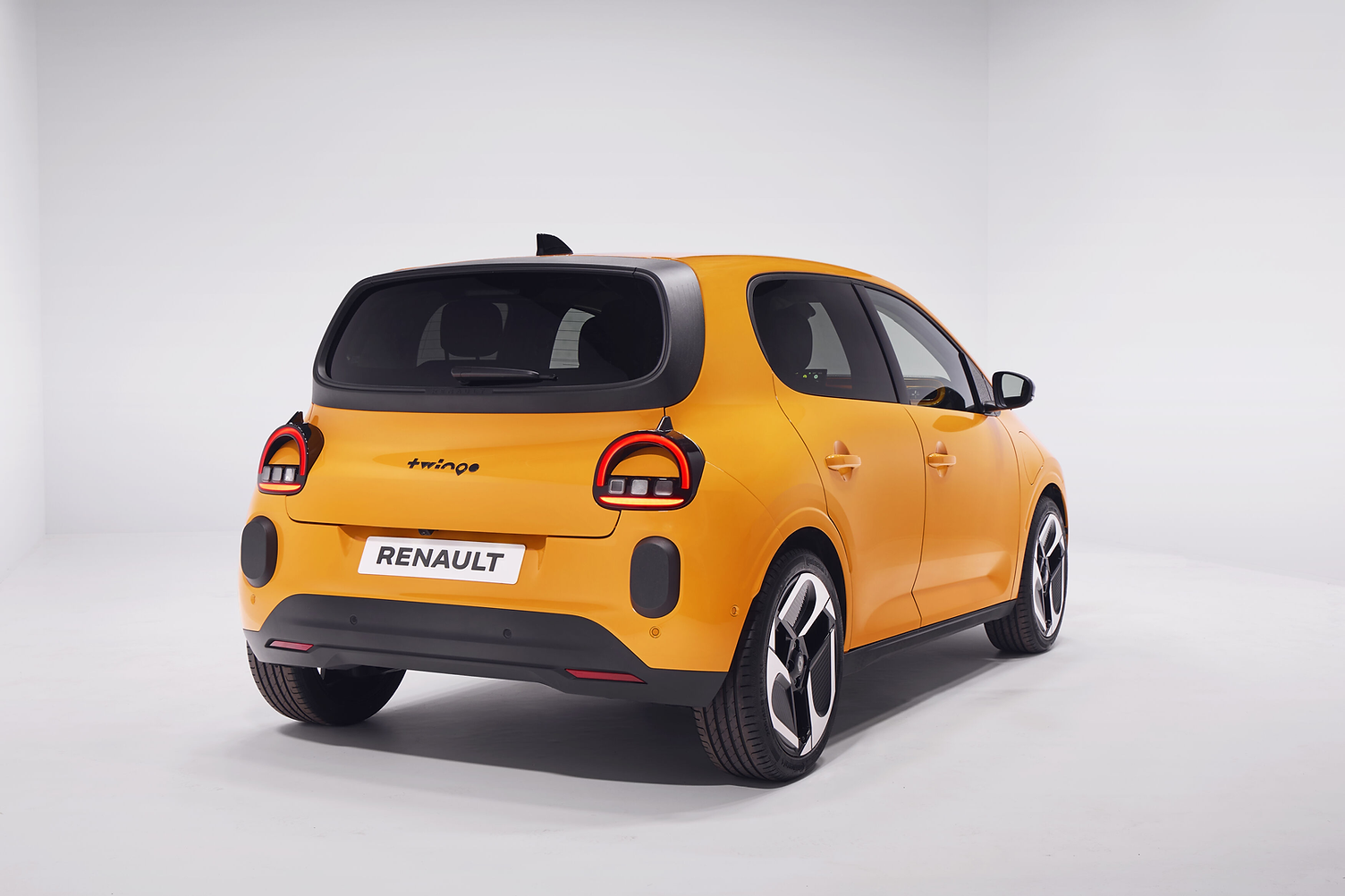 2027 Renault Twingo EV in yellow rear three-quarter profile