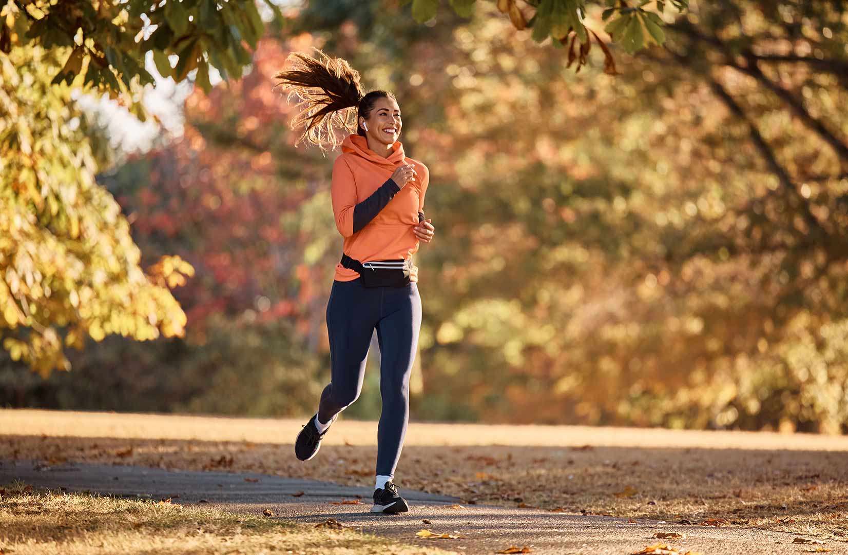 a happy woman running in the park