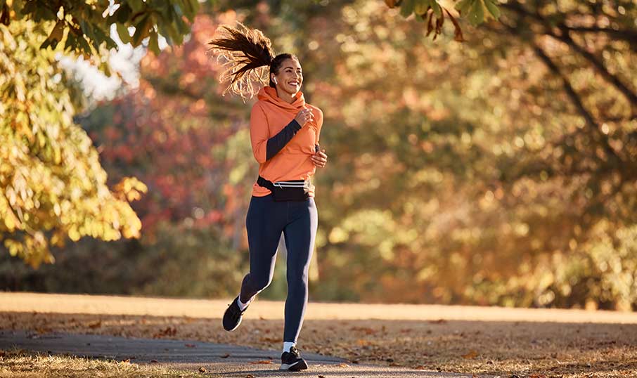 a happy woman running in the park