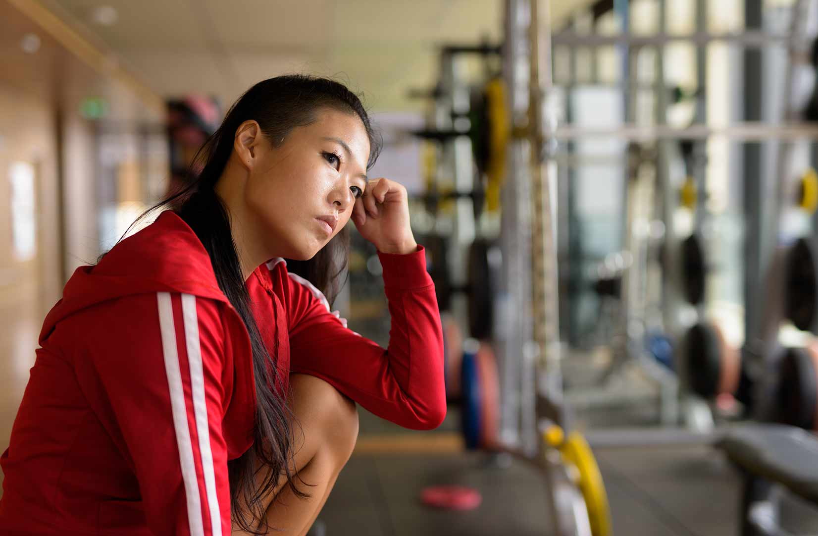 a woman in a gym looking concerned