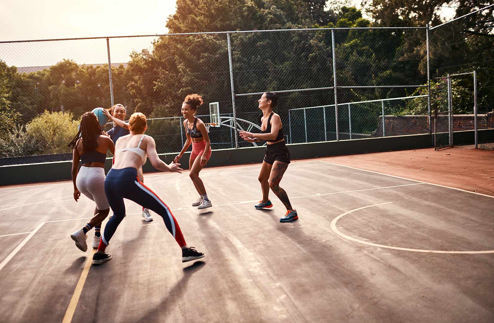 a group of woman playing basketball
