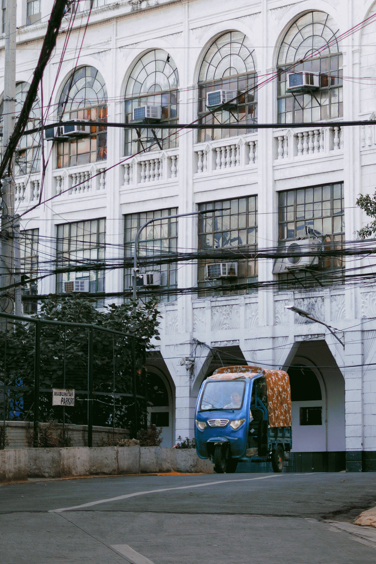 An electronic vehicle in front of a building
